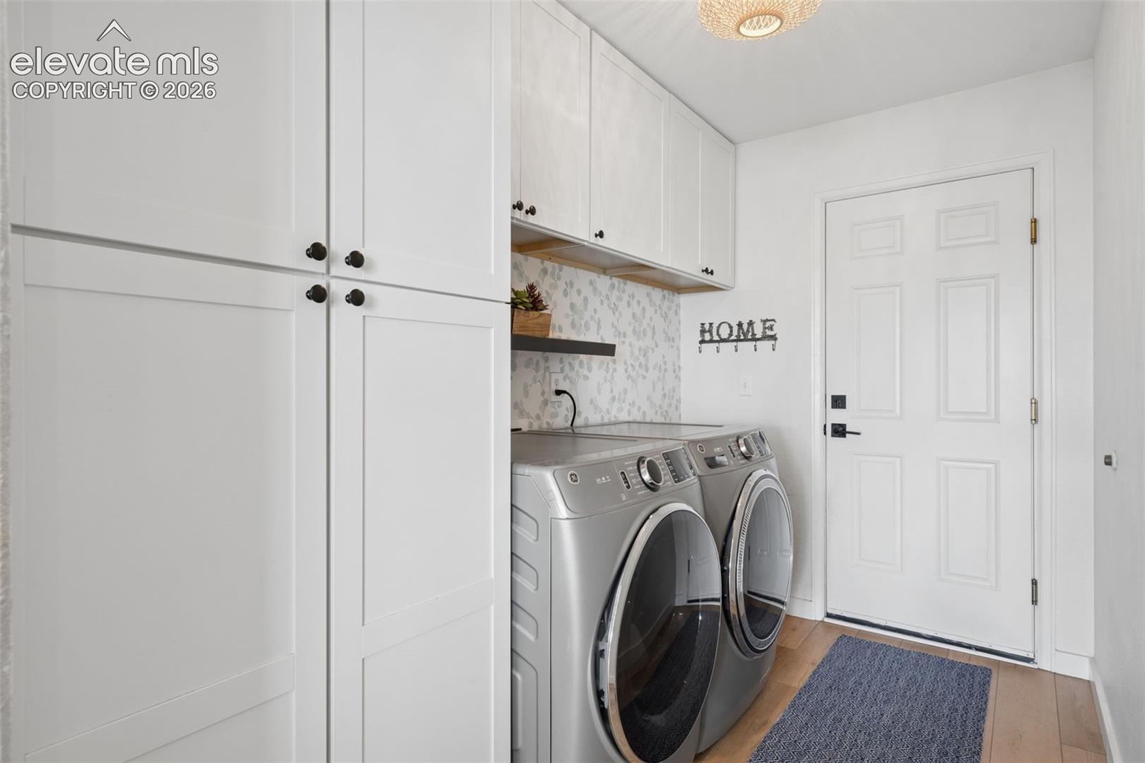 White shaker-style cabinetry with matte black hardware, Pantry, luxury vinyl flooring