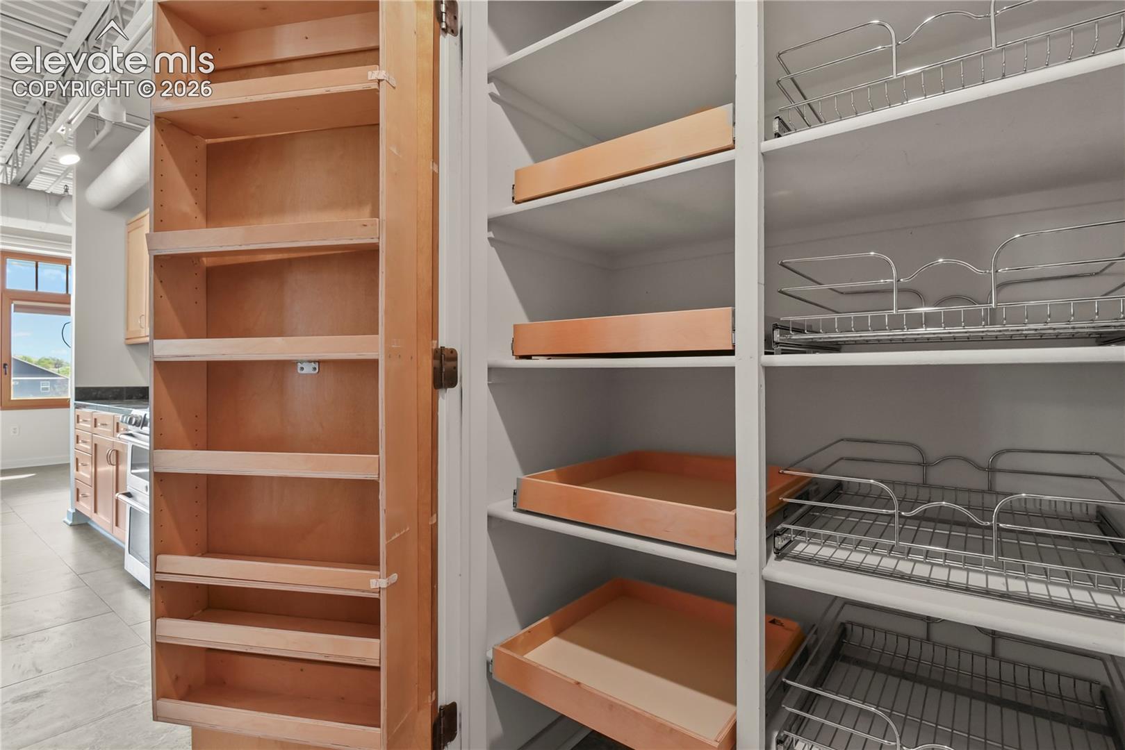 Thoughtfully designed pantry space featuring custom pull-out shelving for effortless organization 