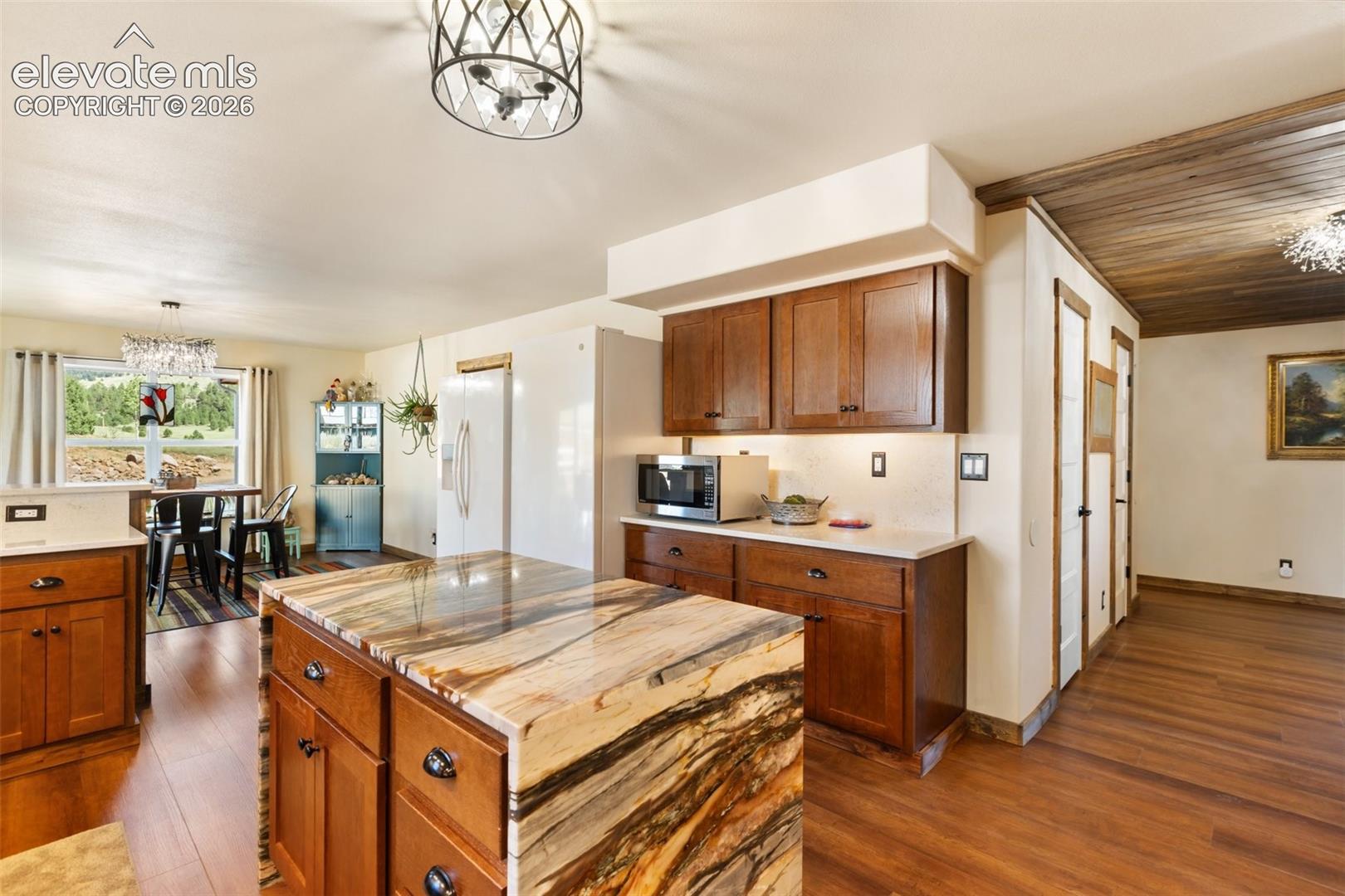 Kitchen flows to the living room to the right and the garage and laundry spaces to the right. 
