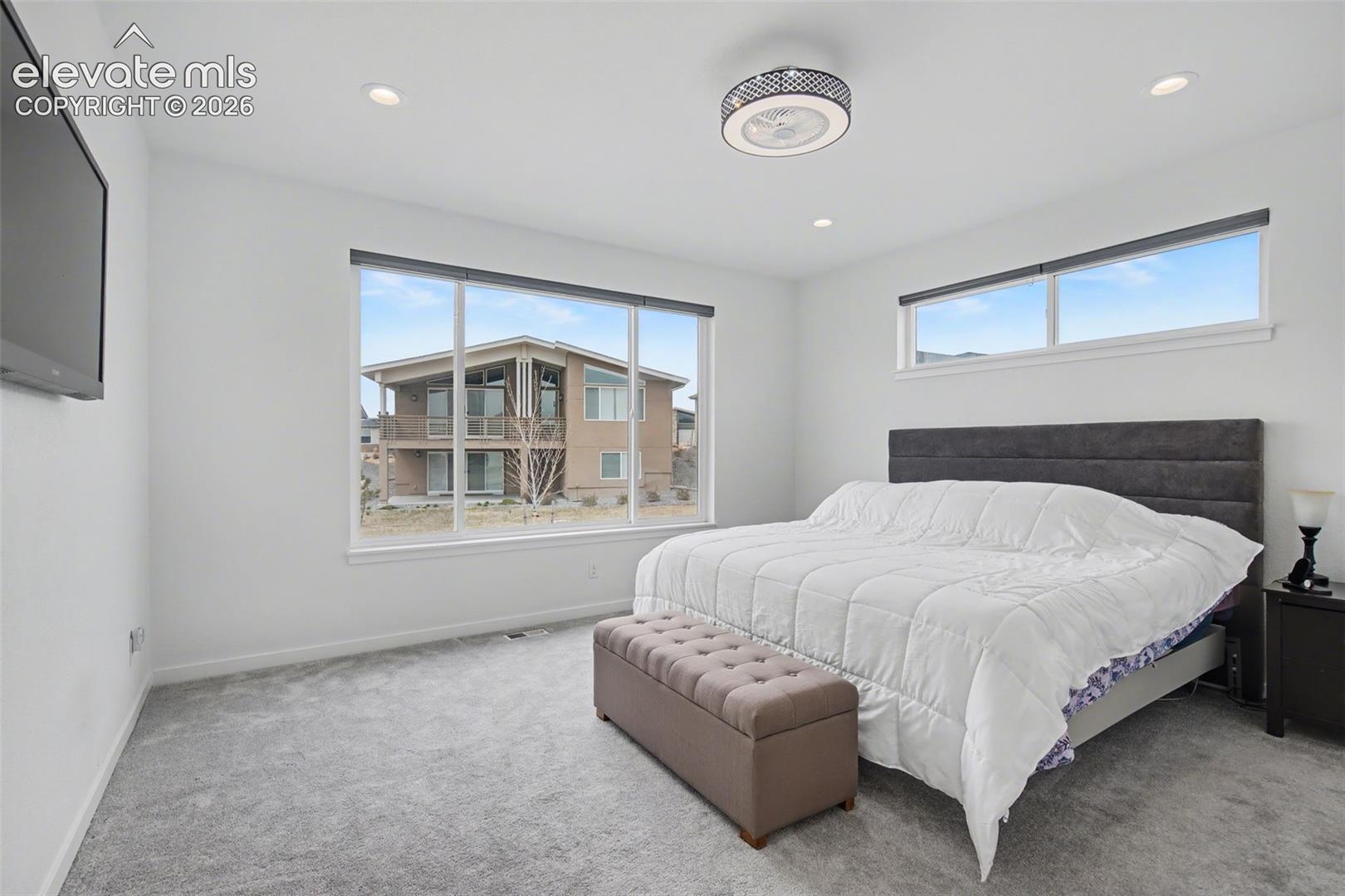 Carpeted bedroom featuring baseboards and recessed lighting
