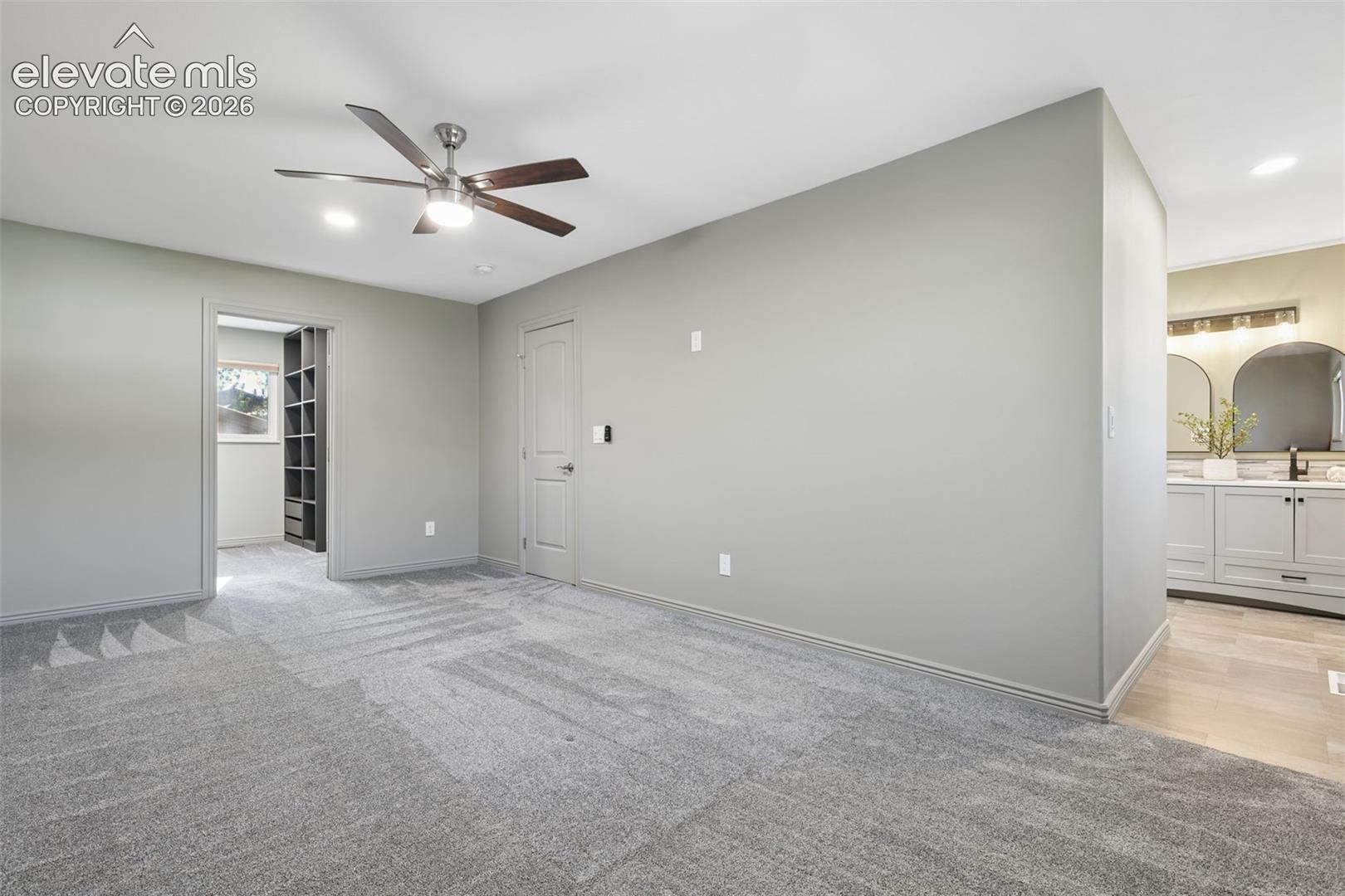 Primary bedroom suite with entrance into WI closet-left and primary bath-right
