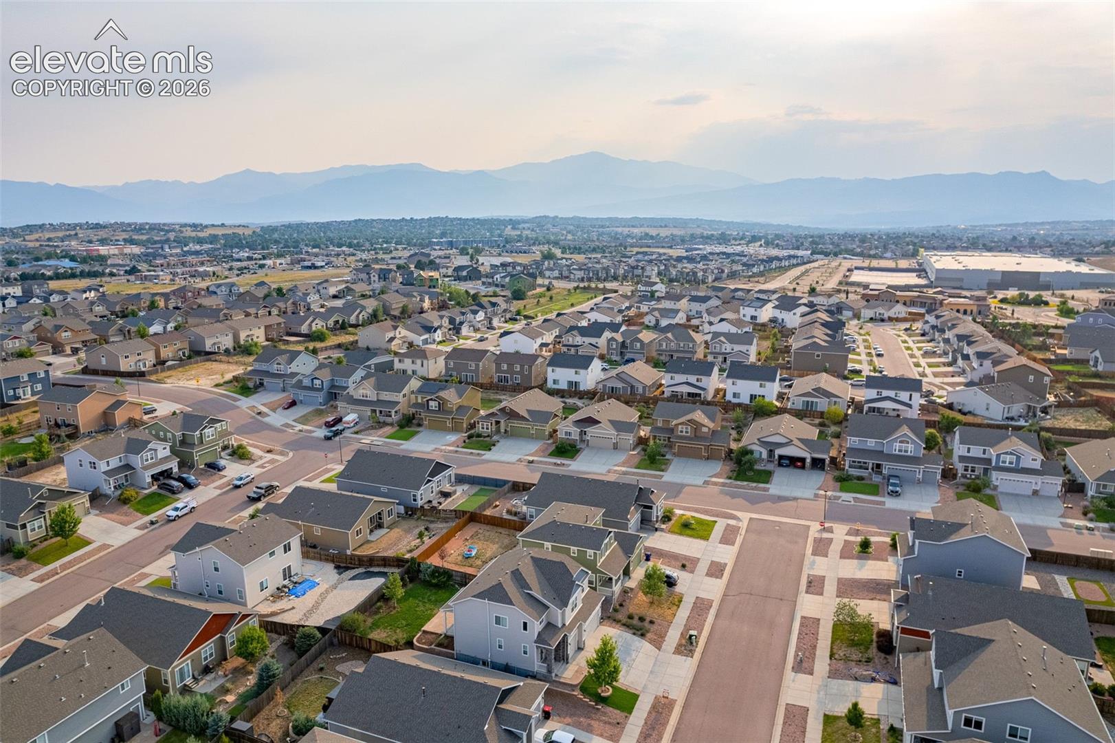 Expansive residential neighborhood with varied architectural styles and mountain scenery