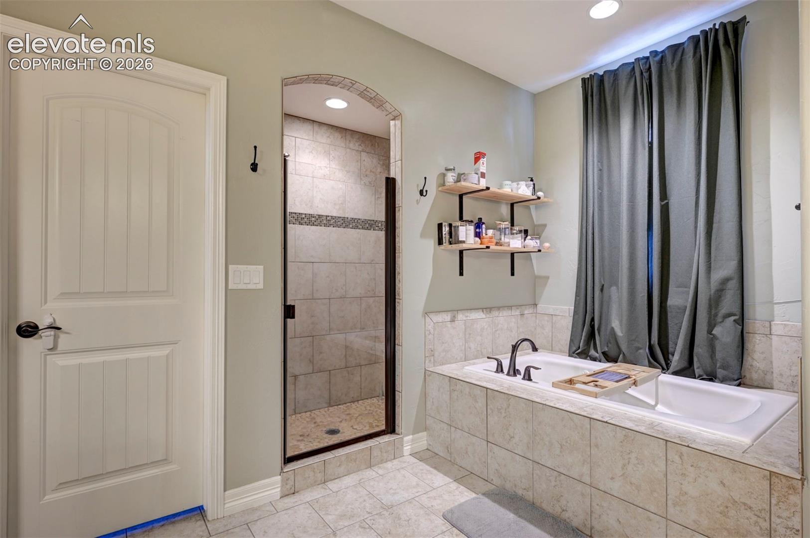 Primary bath: jetted tub and tiled shower