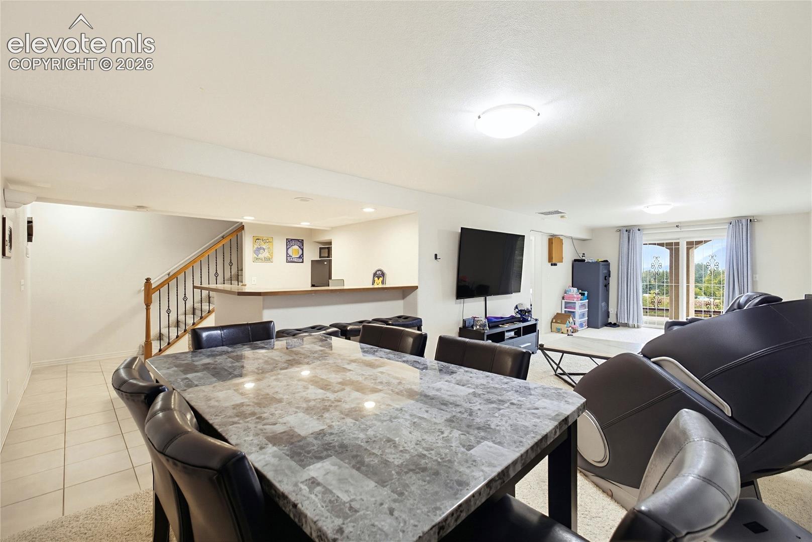 Built-in bar with wood cabinetry, granite-style countertop, integrated sink, and mosaic tile backsplash