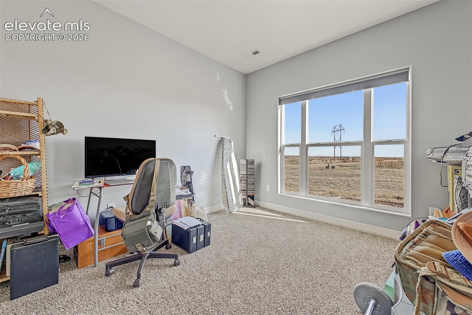 Third bedroom makes a perfect office space with the oversized window and new carpet.