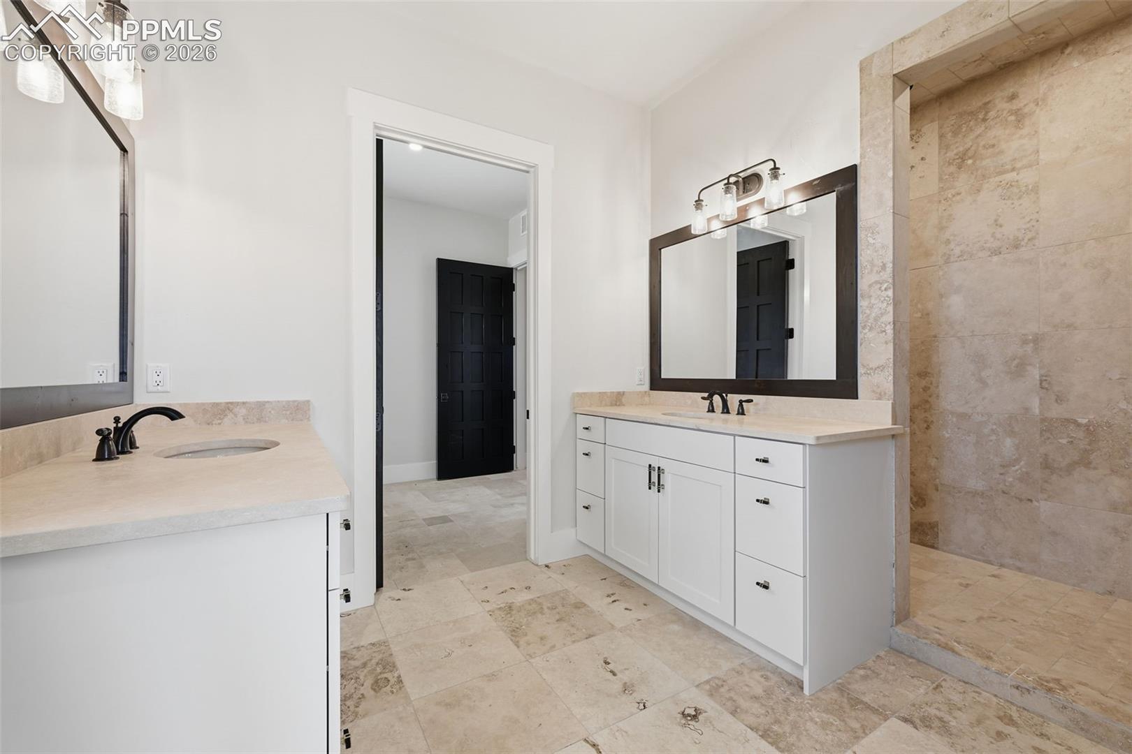Full bath off Master Bedroom featuring two vanities and a walk-in shower.