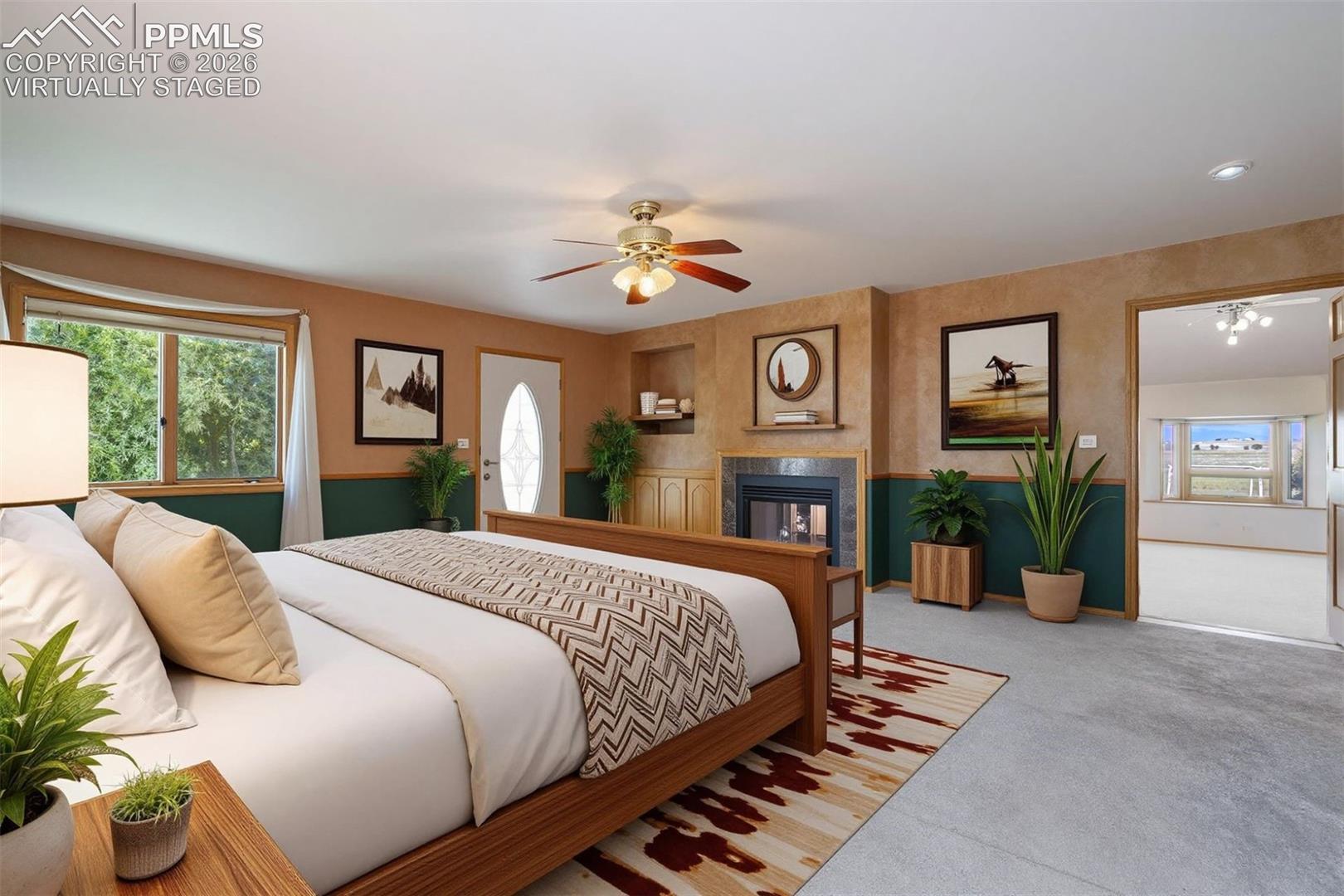 Virtually Staged Primary bedroom featuring a fireplace with tile surround, and built-in shelving