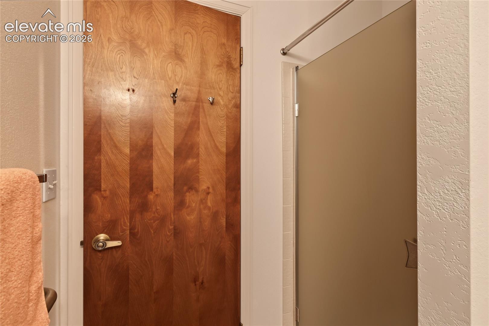 Wood-finish door with a brass-finish handle