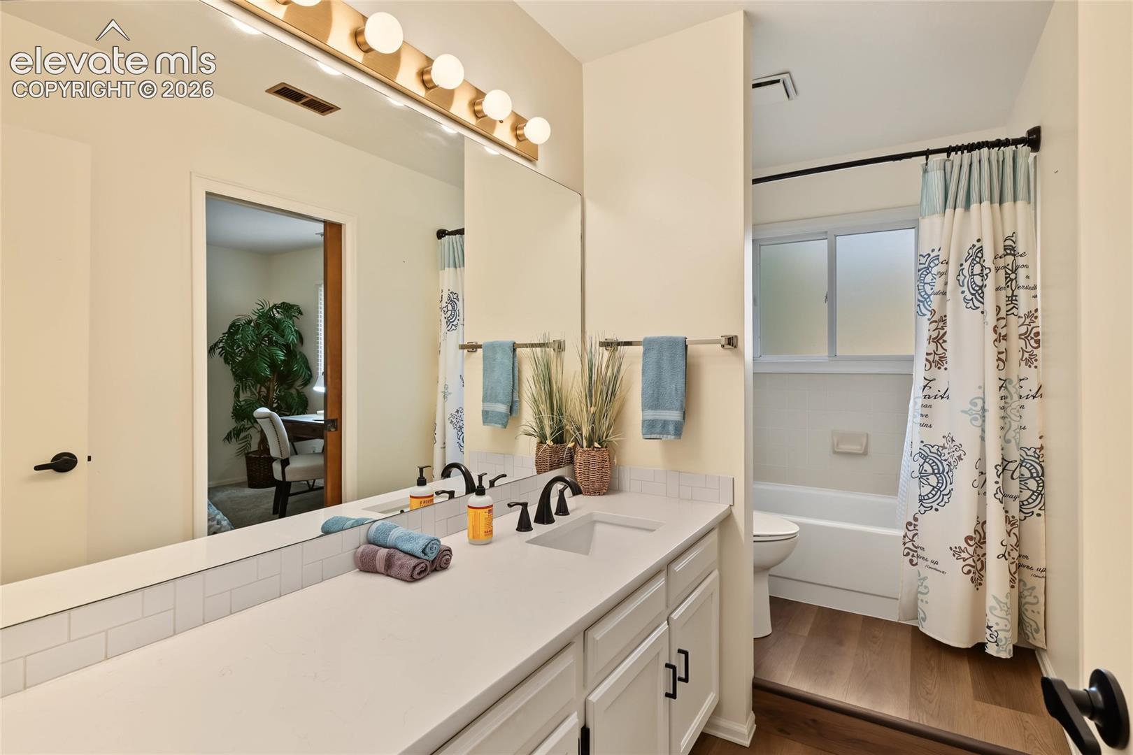 Dual vanity with a single basin, undermount sink, and matte black fixtures