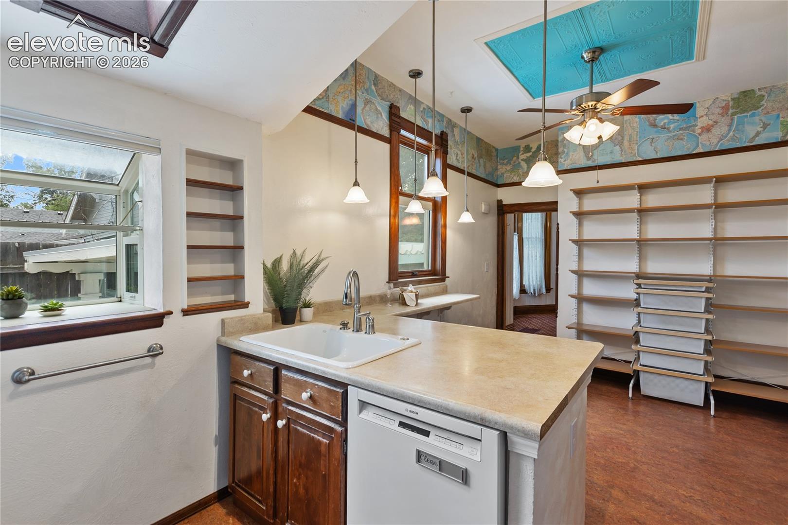 Looking across kitchen peninsula to abundant storage