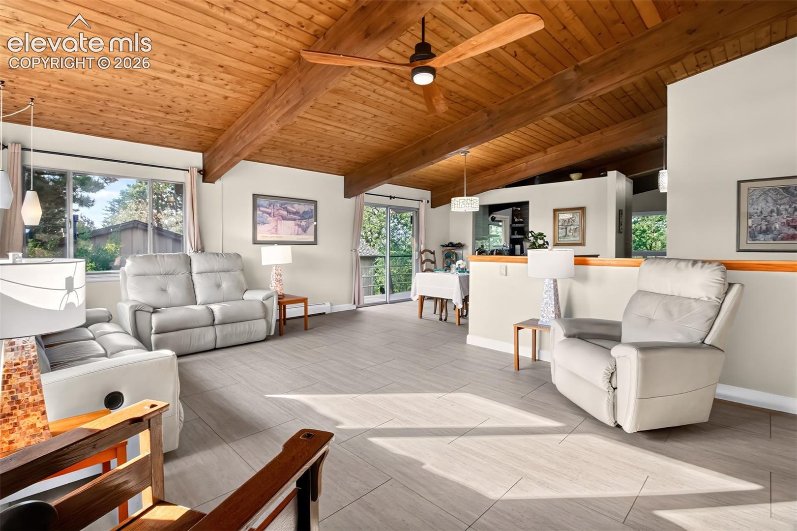 The spacious living room has a luxury vinyl tile flooring.