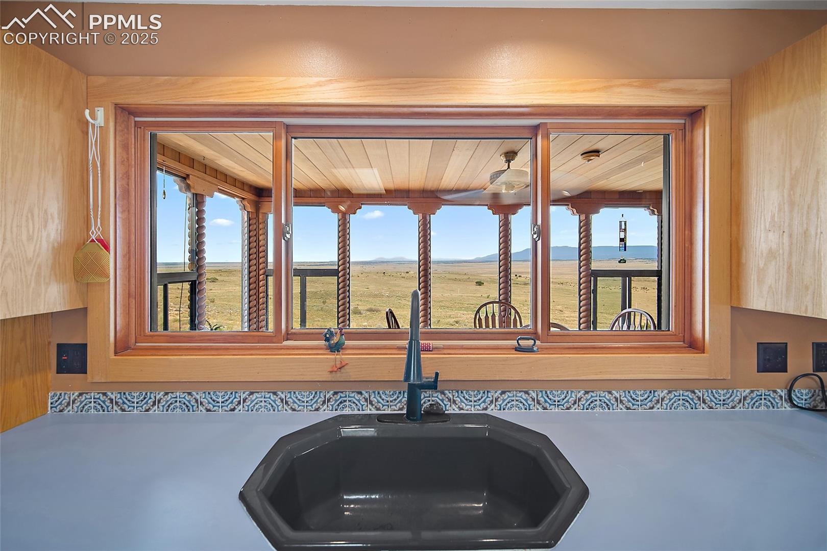 Kitchen view of mountains and light countertops