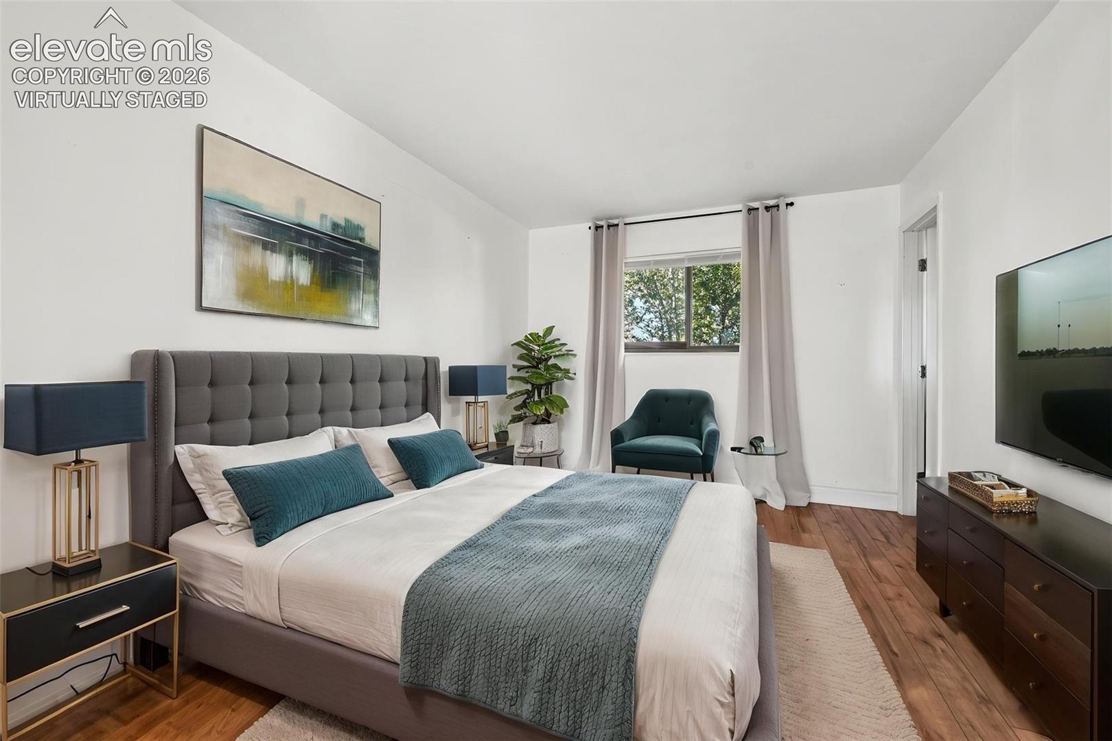 Virtually staged primary bedroom with ensuite and separate sitting area with lots of closet space: LVP flooring.