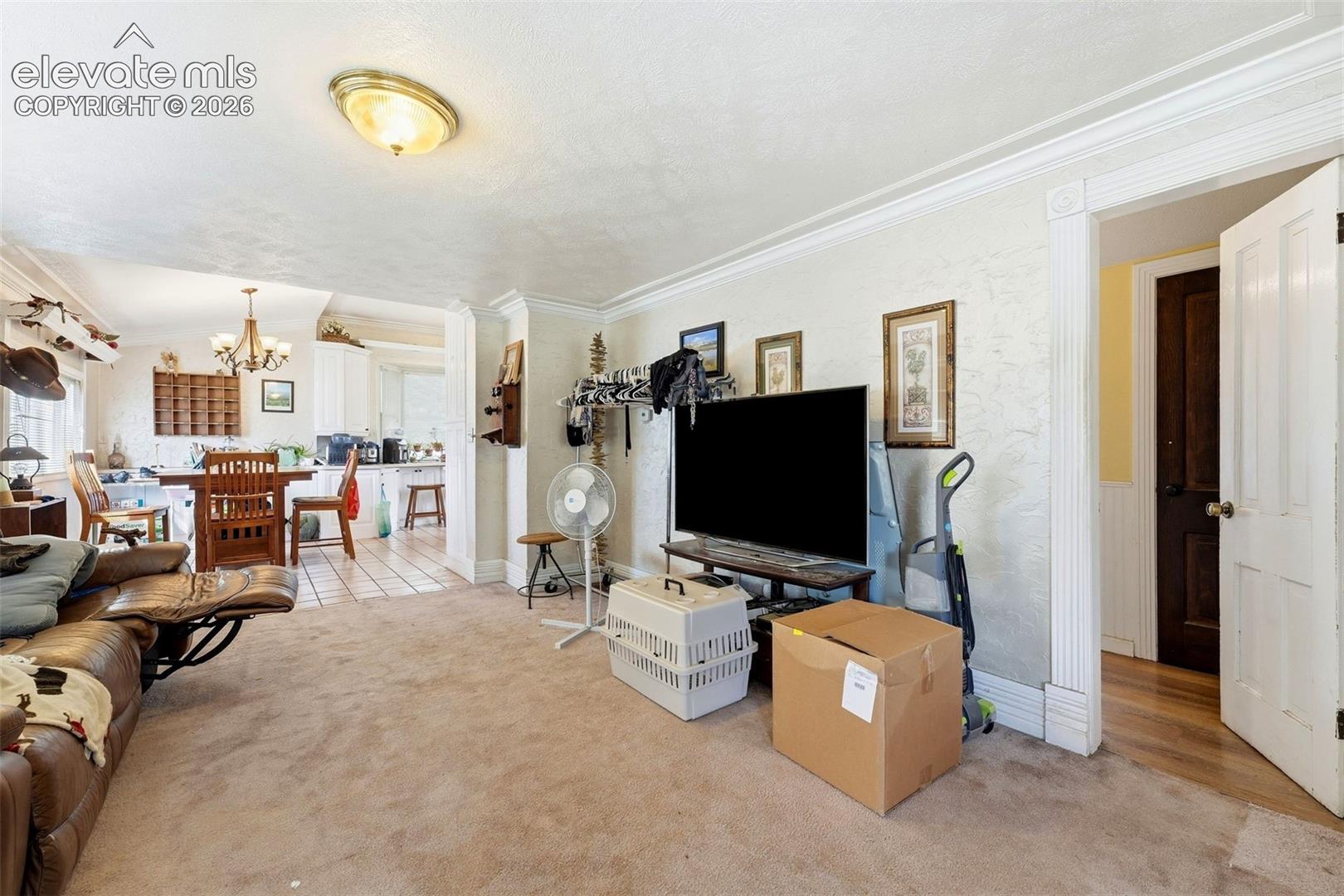 Recessed lighting, crown molding, and an open doorway to the dining area