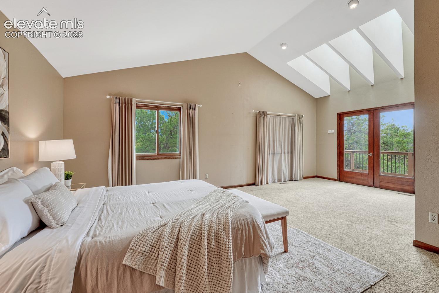 The expansive primary suite has new skylights and French doors that open to a private balcony overlooking the mountains and Pikes Peak.