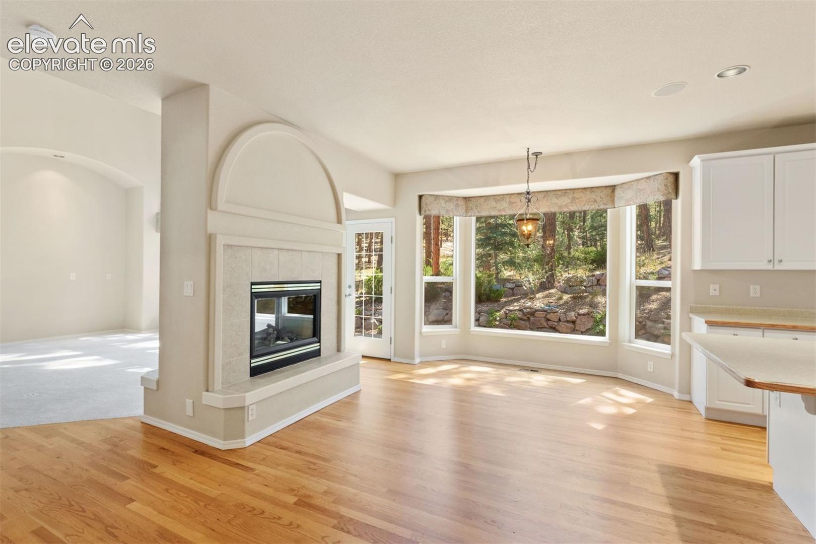 Dining area off kitchen, walkout access, large bay window, dual sided foreplace