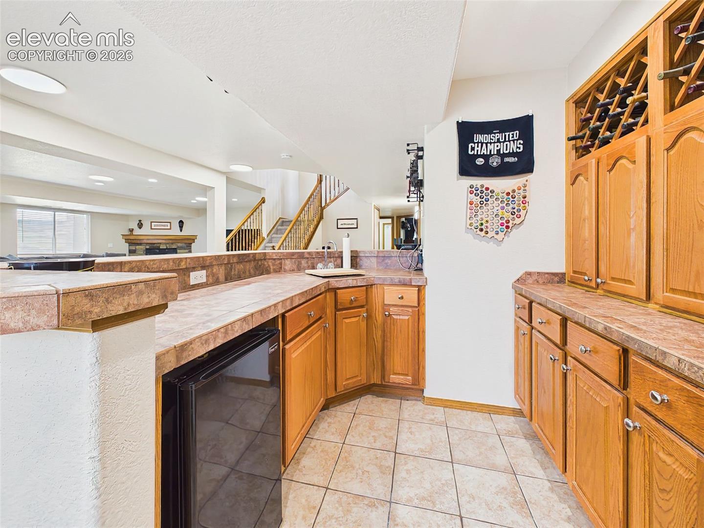 Functional lower-level bar area with extensive cabinetry, prep space, and convenient entertaining amenities.