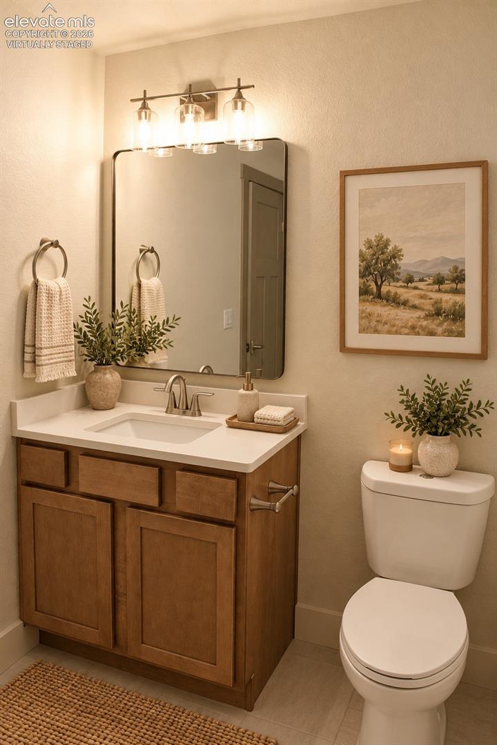 Virtually staged Vanity with wood-finish cabinetry, white countertop, and integrated sink