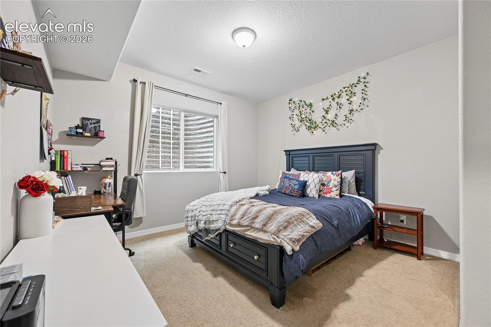 Bedroom #5 is tucked into another corner of the basement, but is big enough for daily life, including a desk.  The good-sized closet is just out-of-frame to the right.
