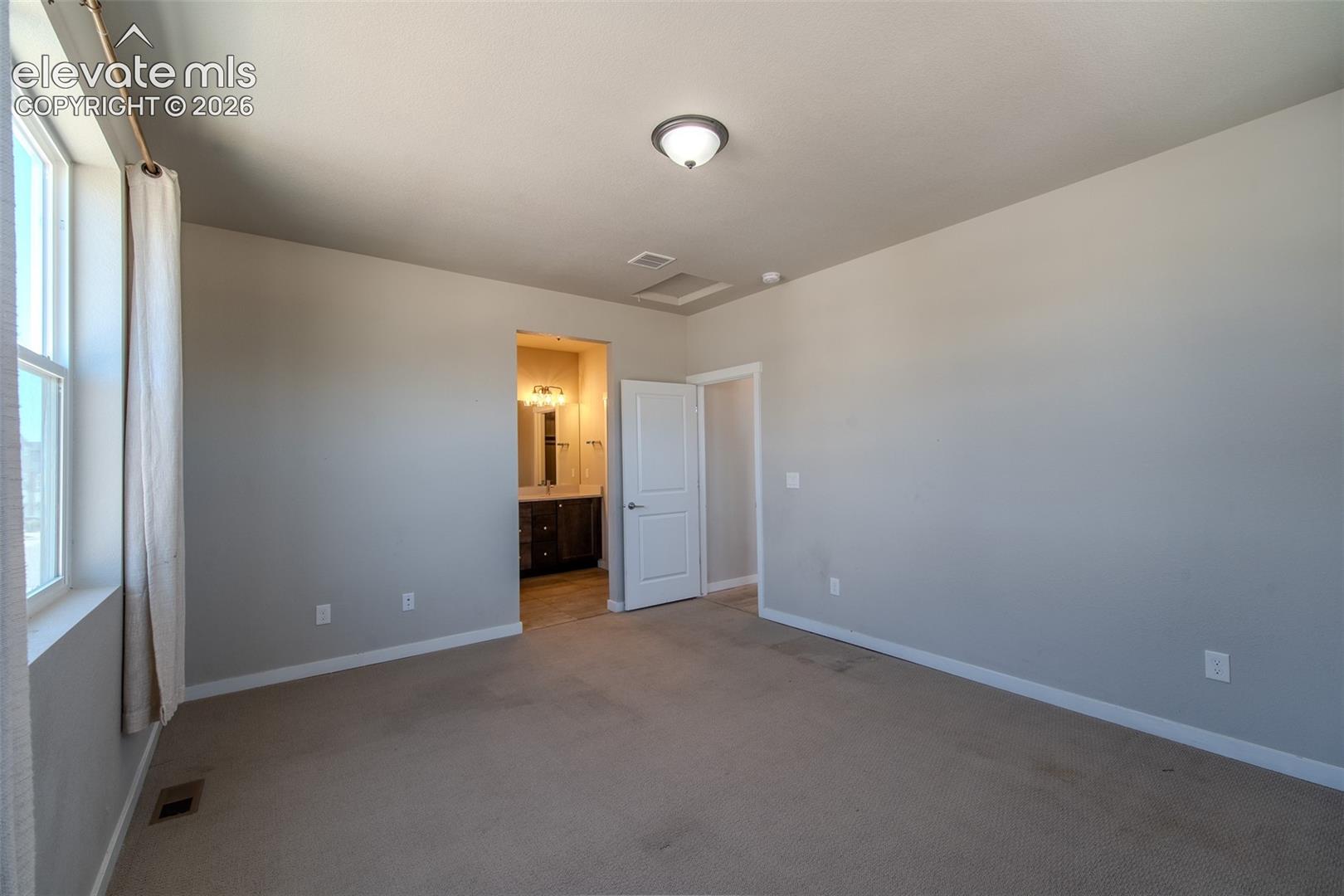 Spacious Upper Level Primary Bedroom with adjoining Shower Bathroom.