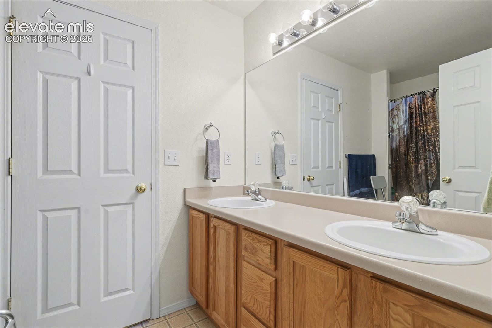 Upper level full bathroom with dual vanity sinks