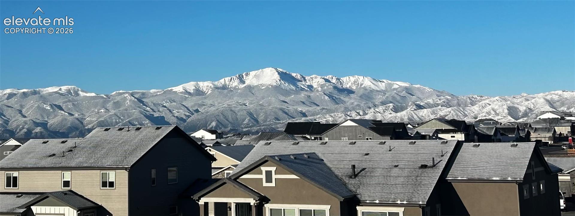 Neighborhood setting with snow-capped mountain backdrop