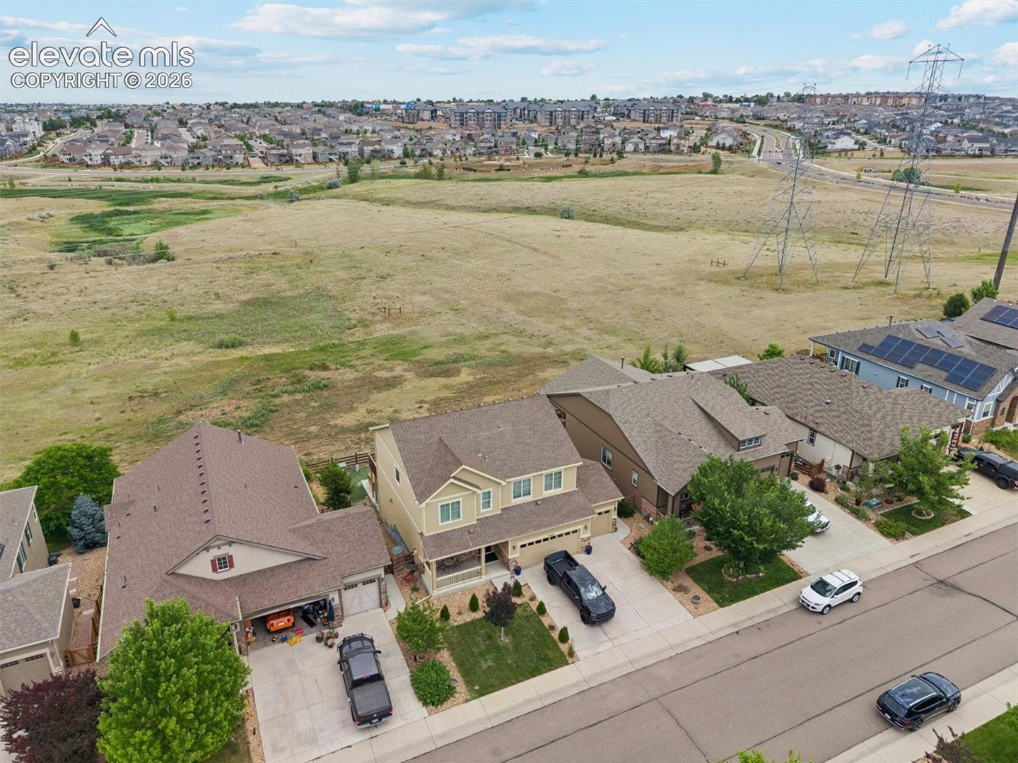 Suburban residence featuring a two-story design with a covered porch and an attached garage