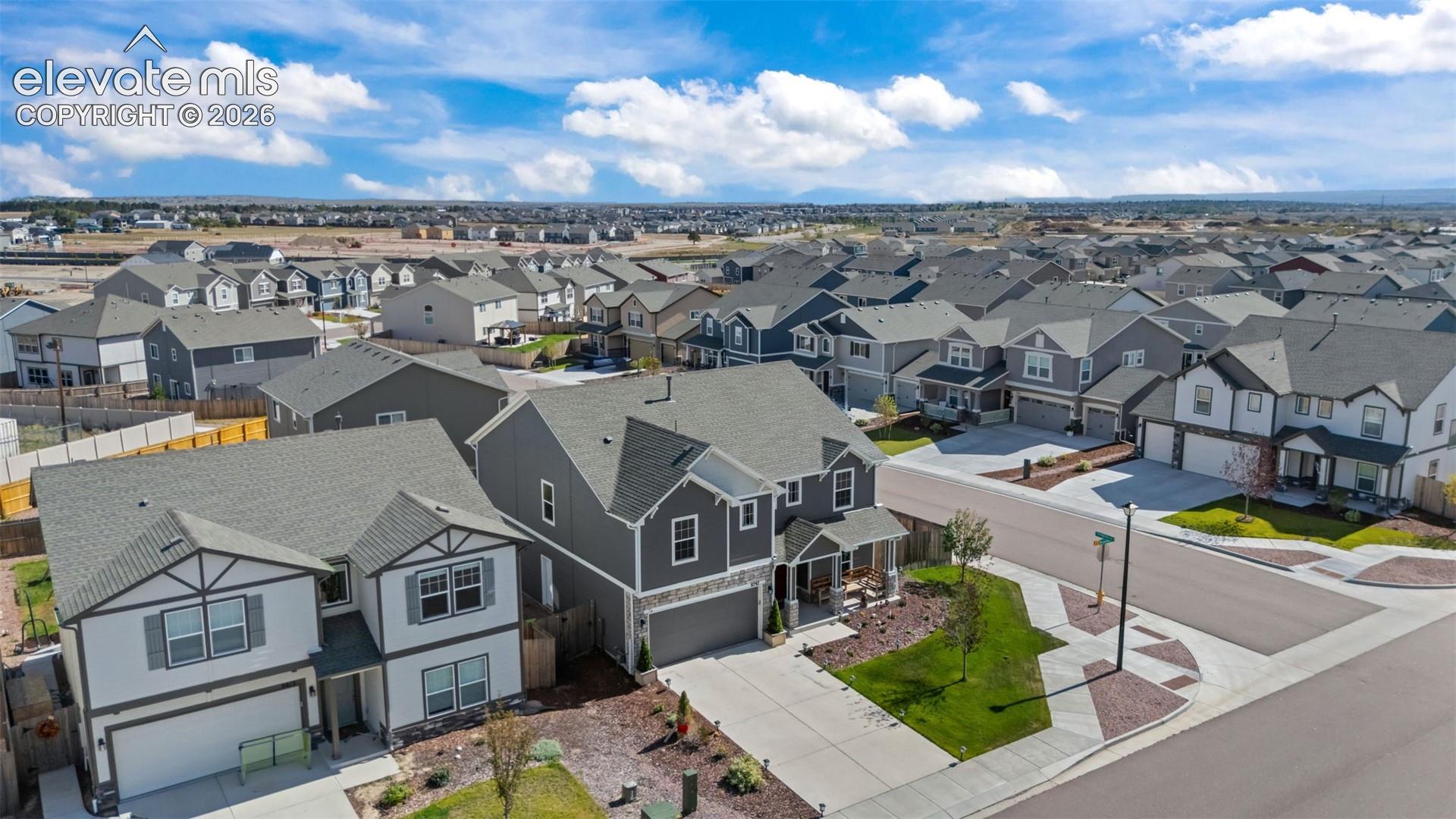 Contemporary residential development featuring diverse architectural styles, paved roadways, and landscaped common areas