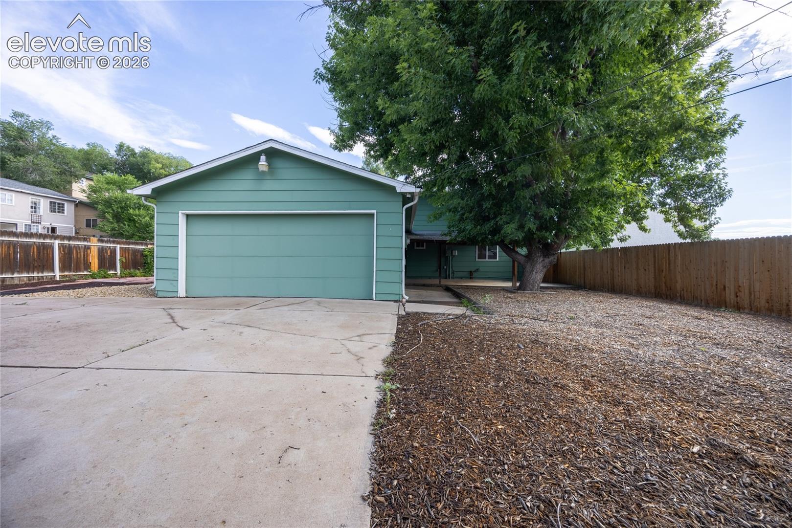 Large backyard with double car attached garage