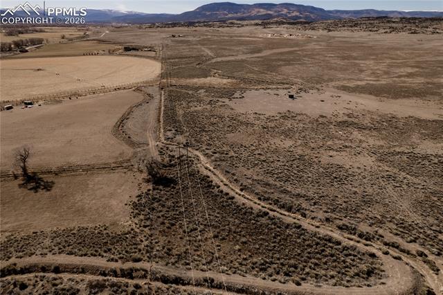 Overview of rural landscape featuring a desert landscape and a mountainous background
