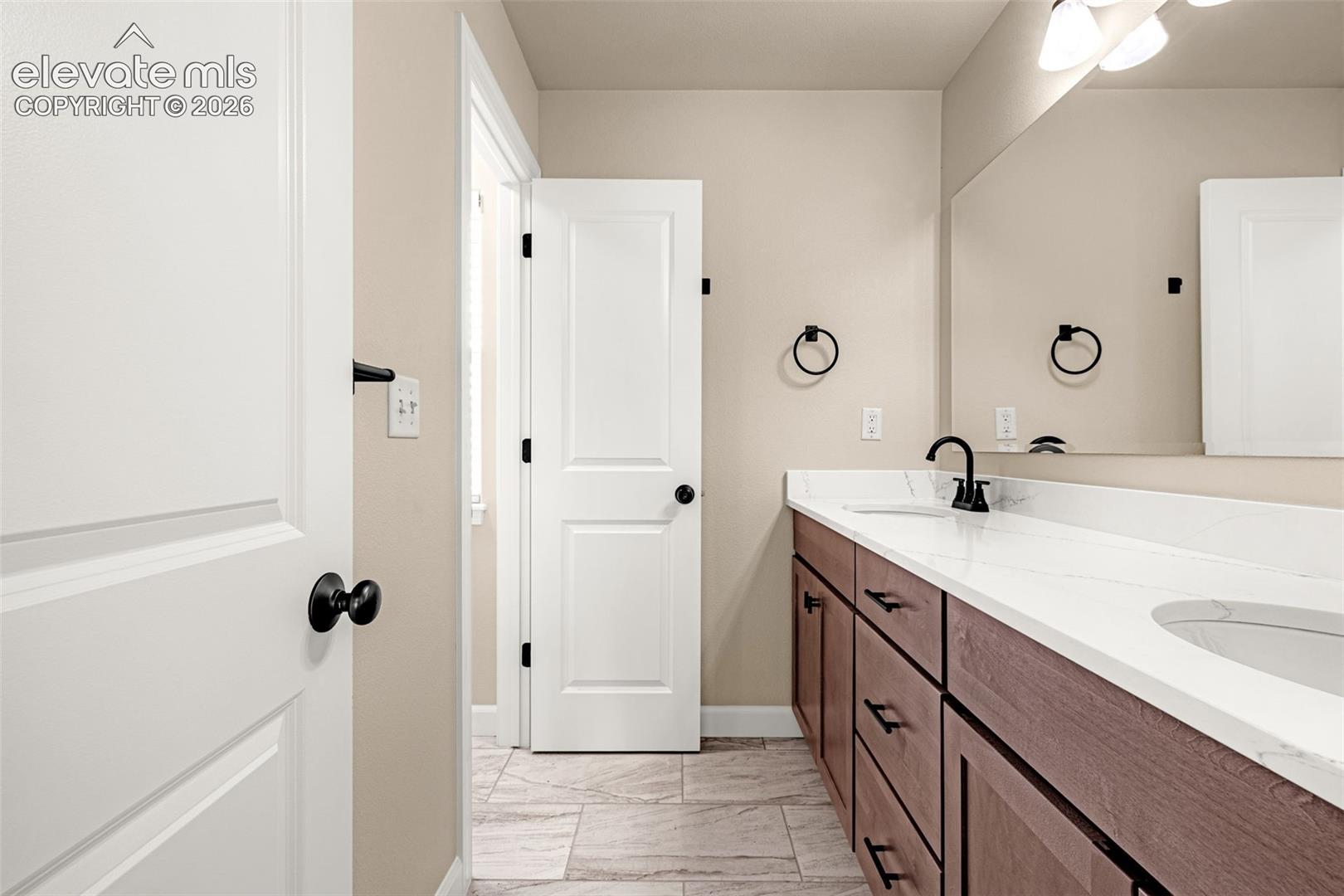 Full bathroom with two sinks, ample cabinets space with a separate tub/shower and toilet helps those morning rushes.  