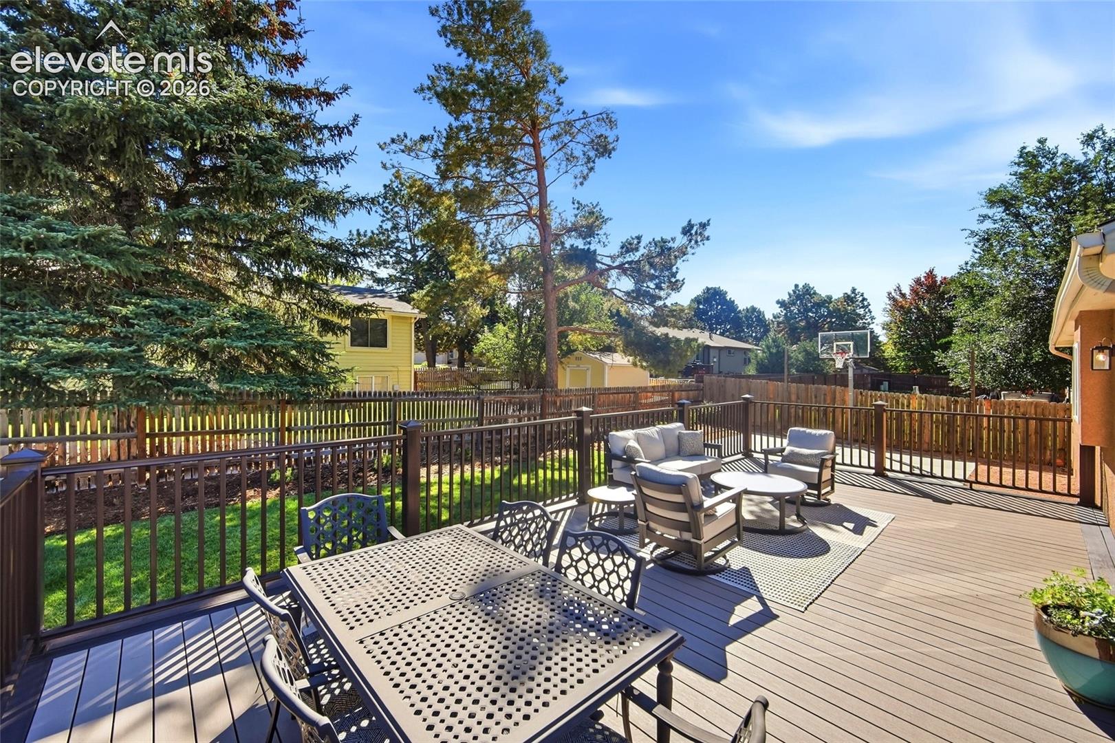 Expansive outdoor deck with composite decking, dark railings, and a privacy fence