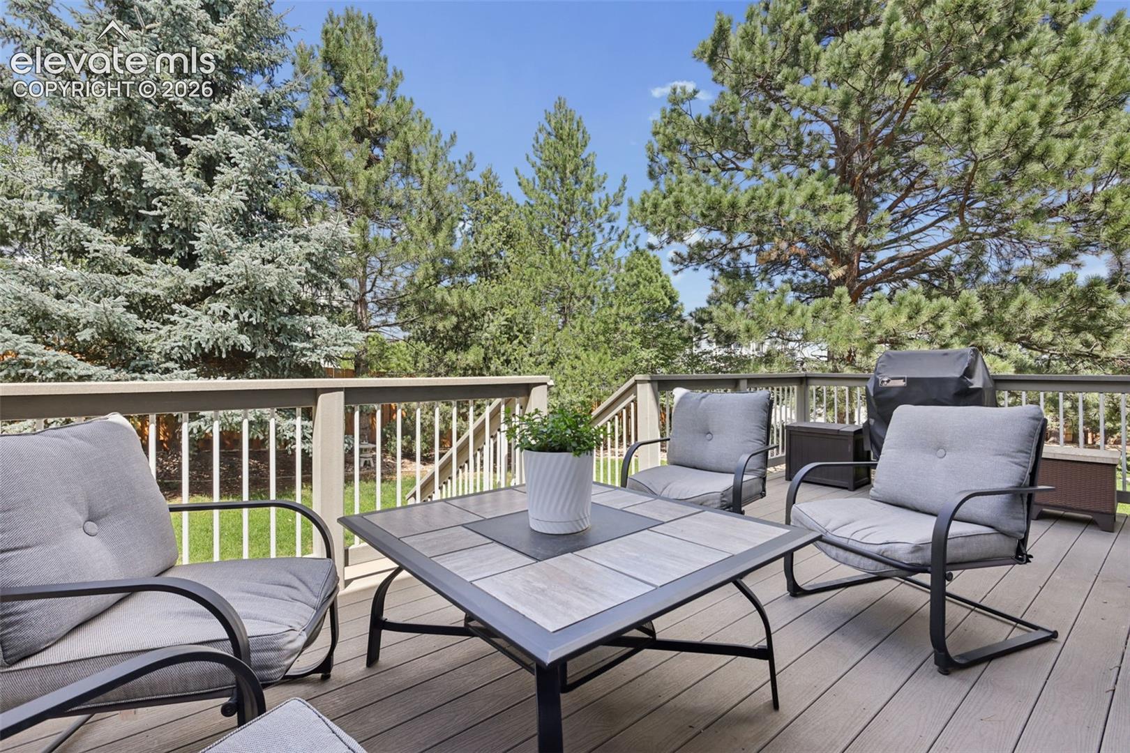 Rear yard deck with mature trees for added privacy