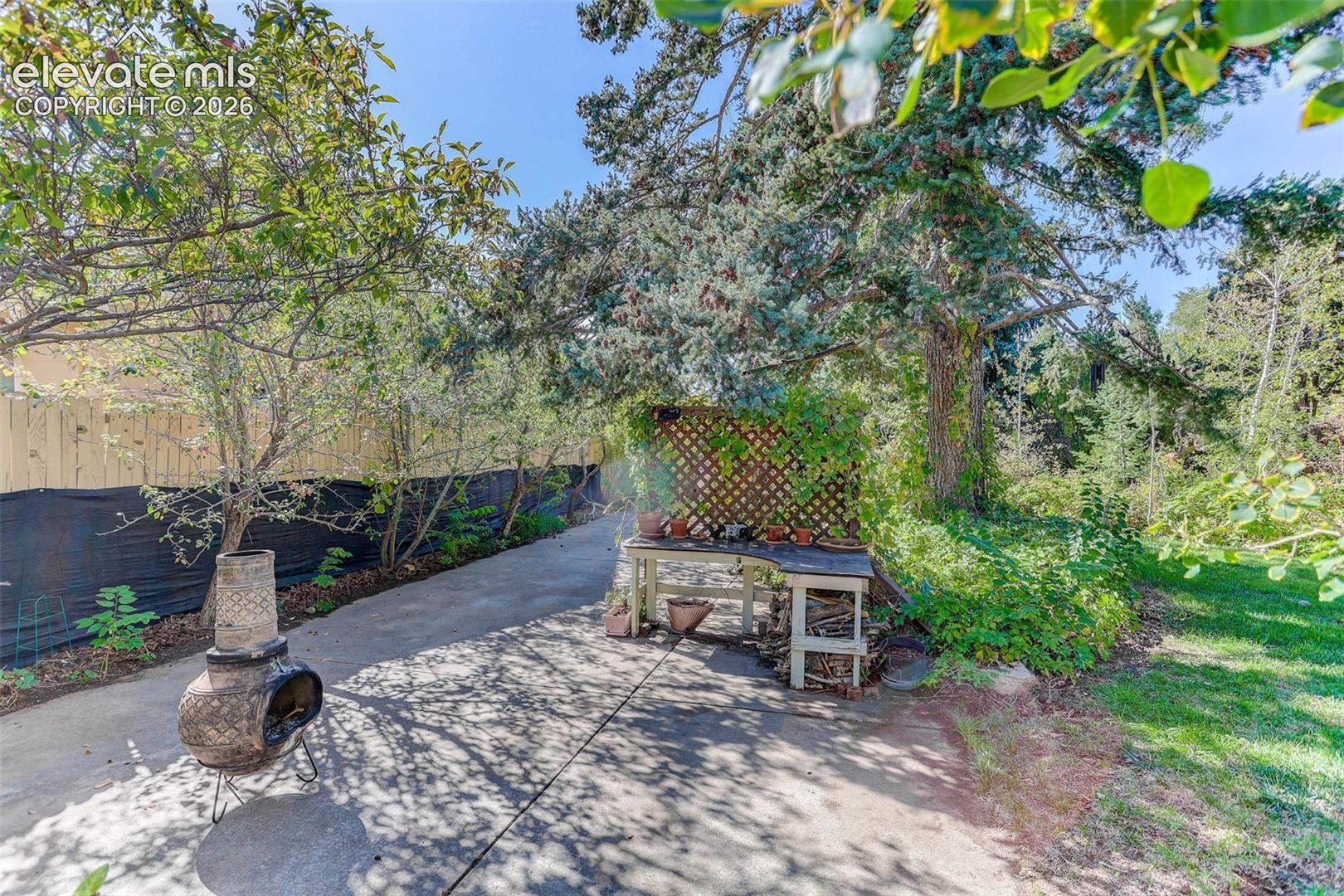 Concrete pathway with a wooden fence