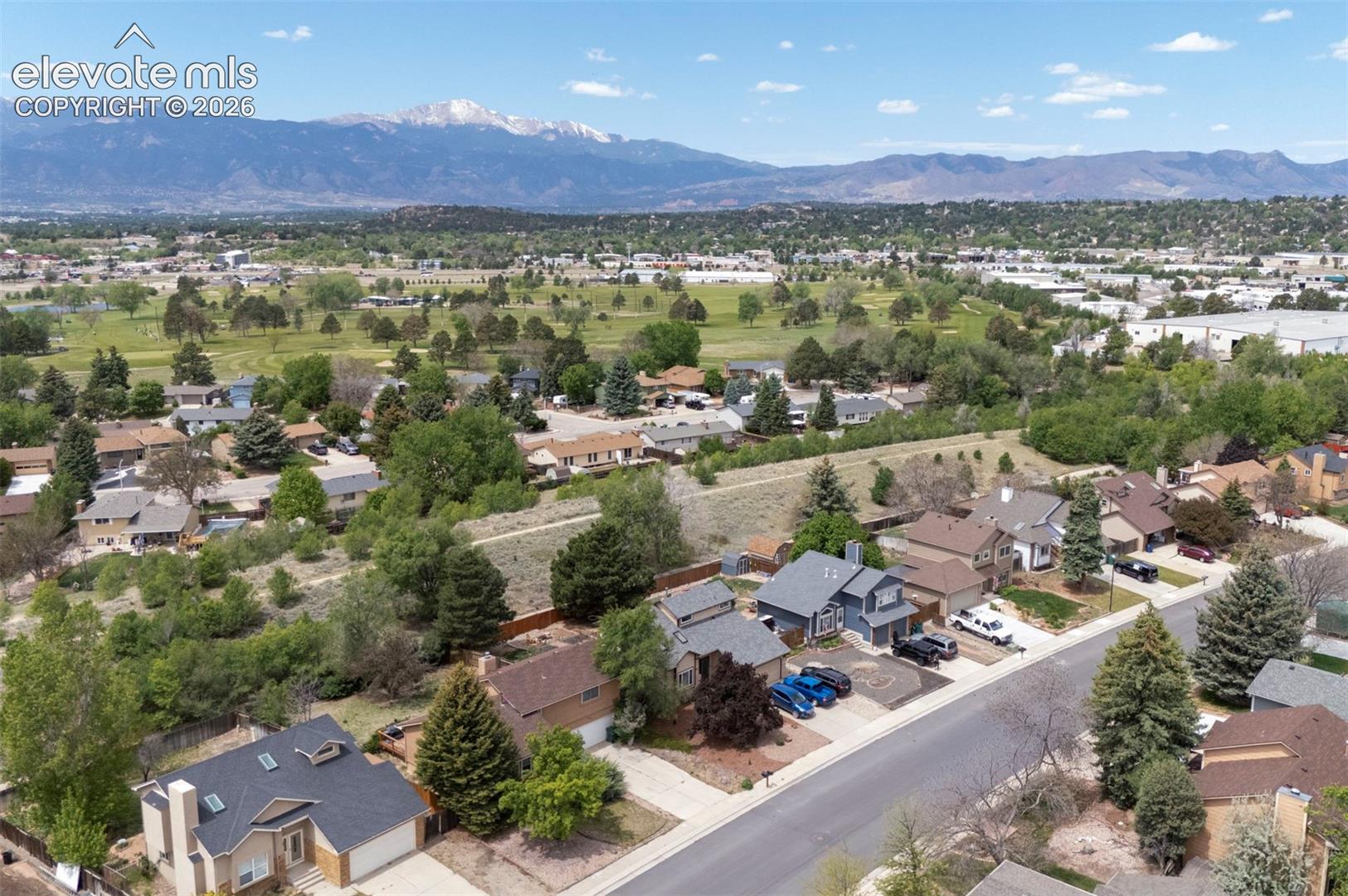 Residential neighborhood featuring a mix of single-family homes, mature trees, and paved streets
