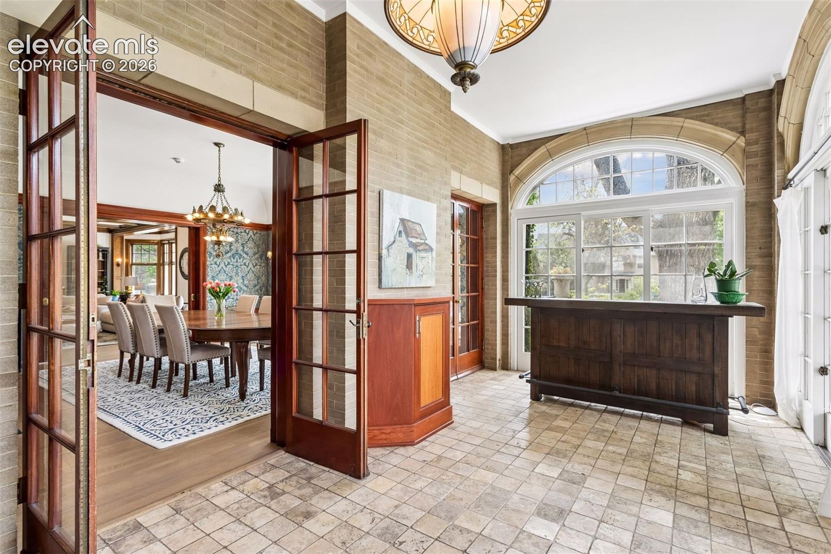 Sunroom off of kitchen and dining room leading to veranda
