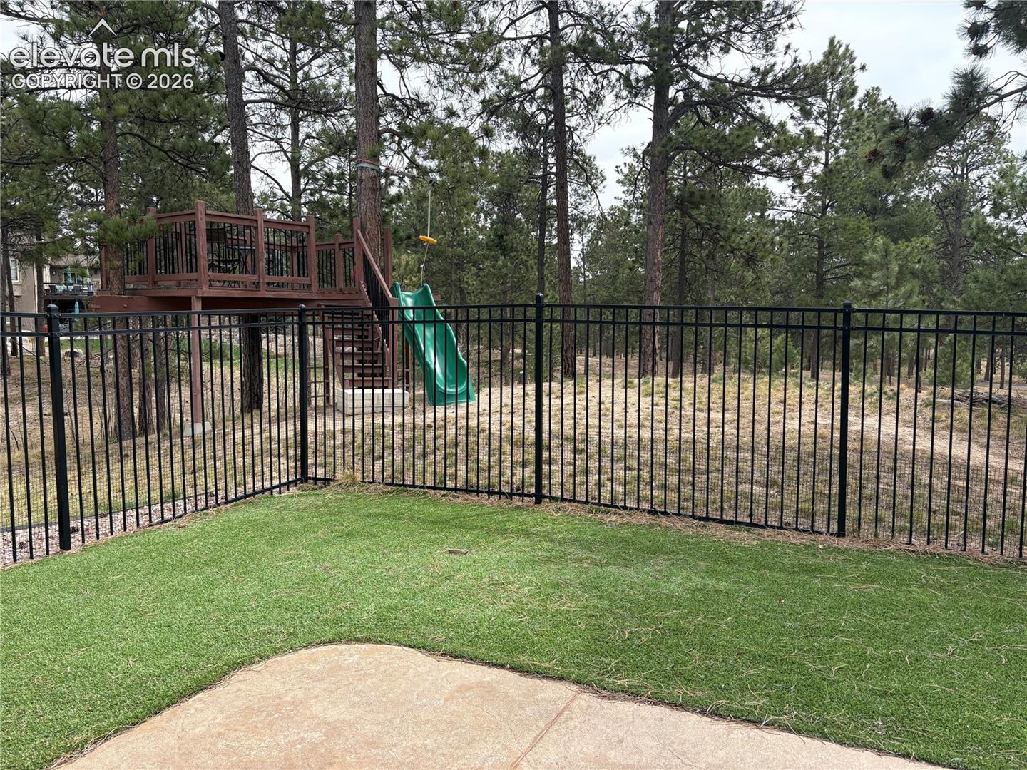 View from lower level in dog run and little tree house with zip line