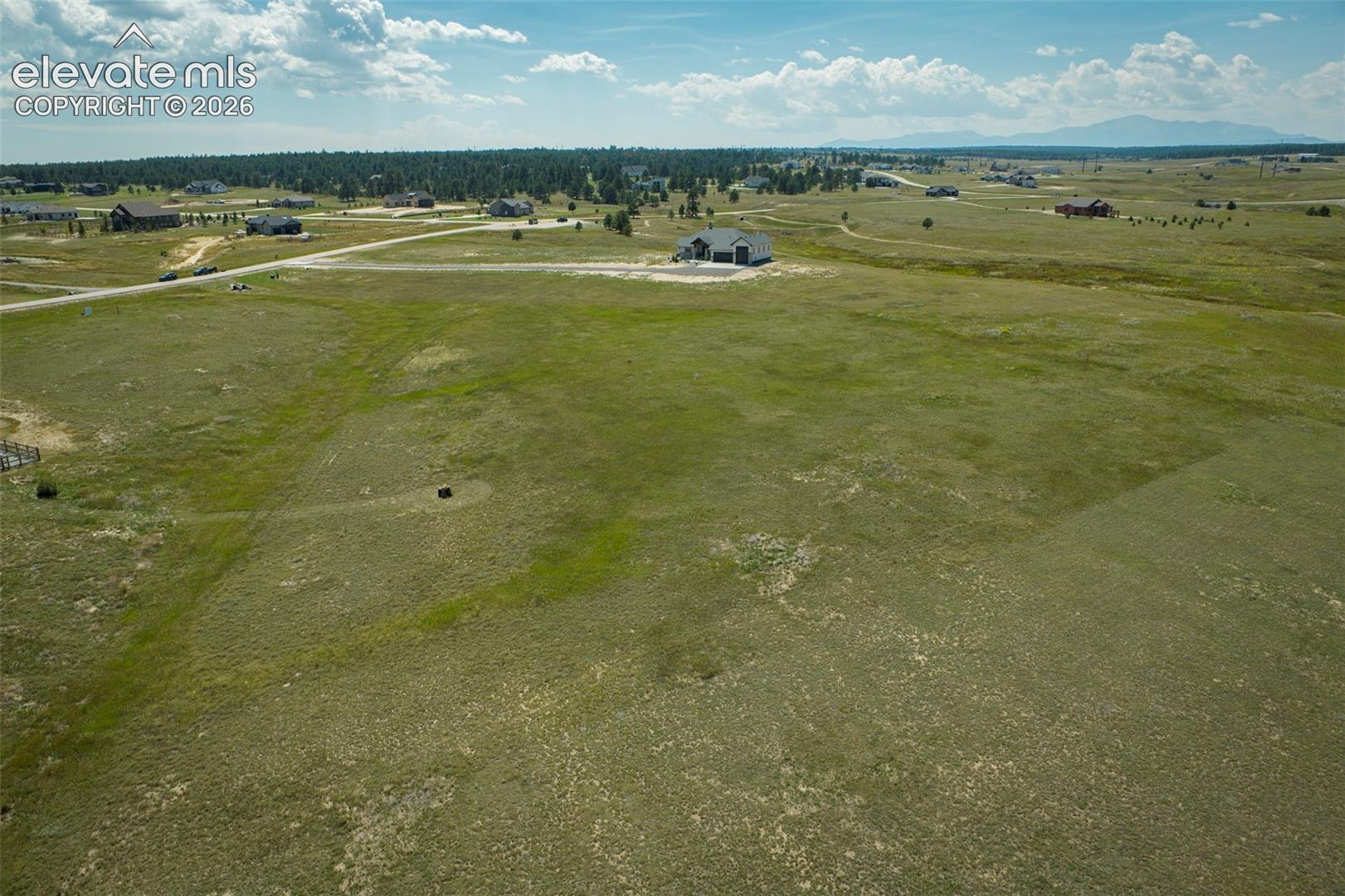 Expansive acreage featuring native grasslands and distant mountain topography