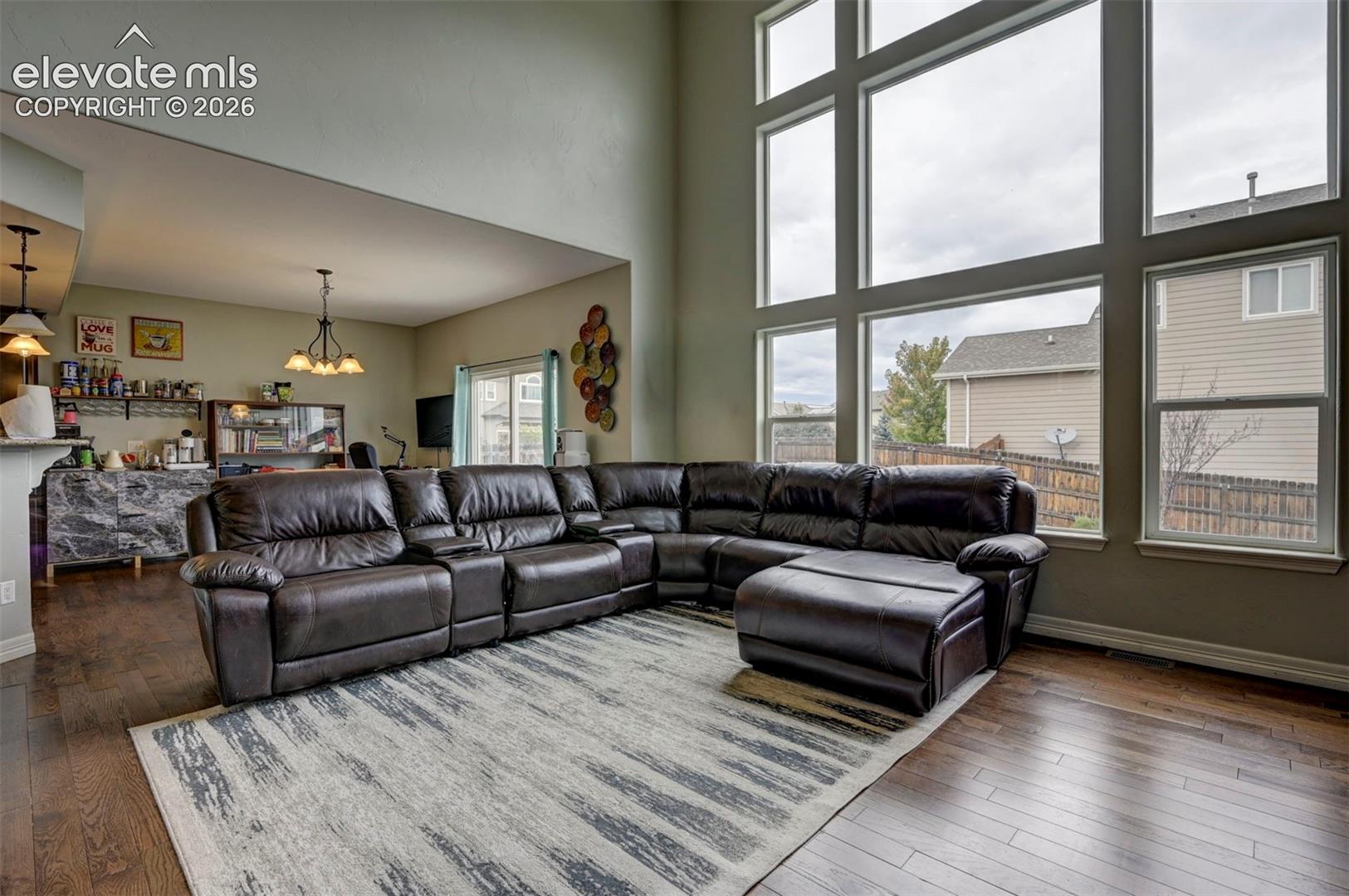 Great room with a wall of windows, open to the kitchen