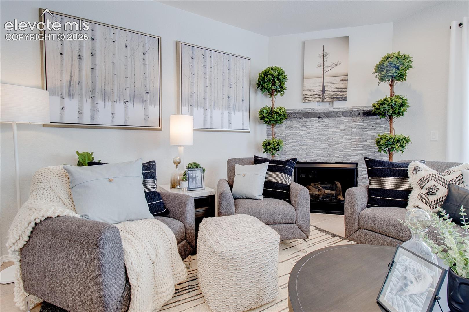 Corner fireplace featuring a floor-to-ceiling stacked stone surround
