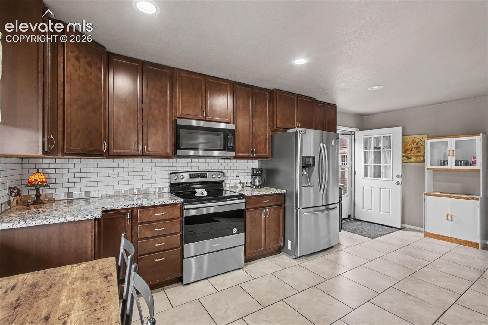 Bright and functional kitchen featuring a convenient walkout to the outdoor space.