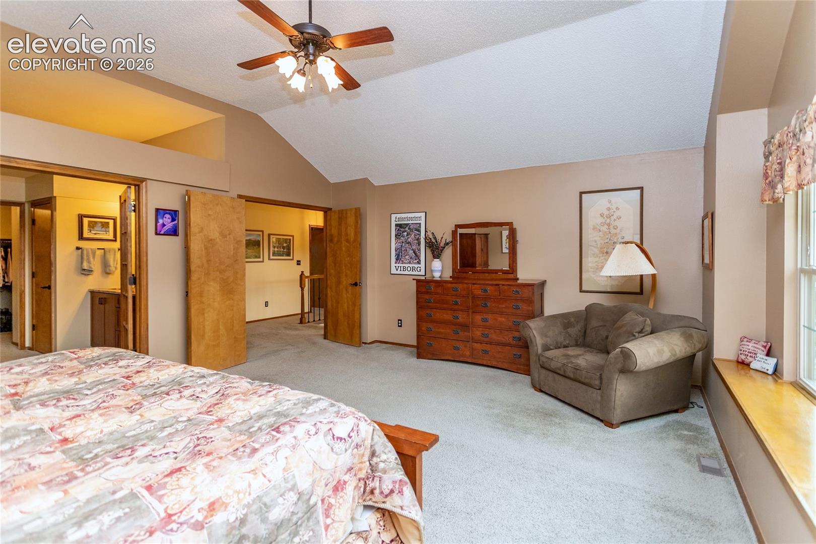 Primary Bedroom with French Doors and Private Bathroom Suite