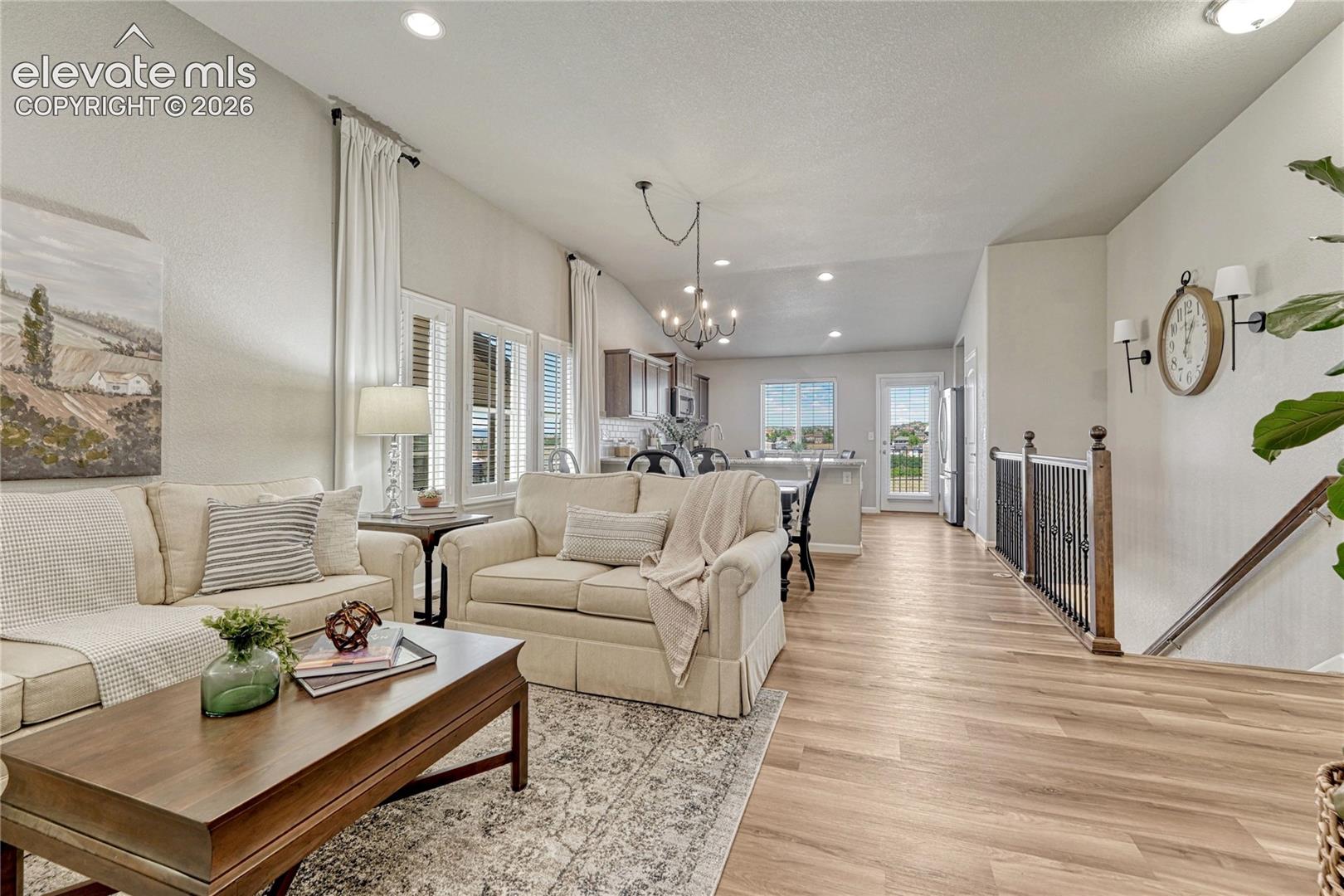 The open living area provides a flexible space for relaxing, entertaining, and everyday life with vaulted ceilings and seamless flow into the kitchen.