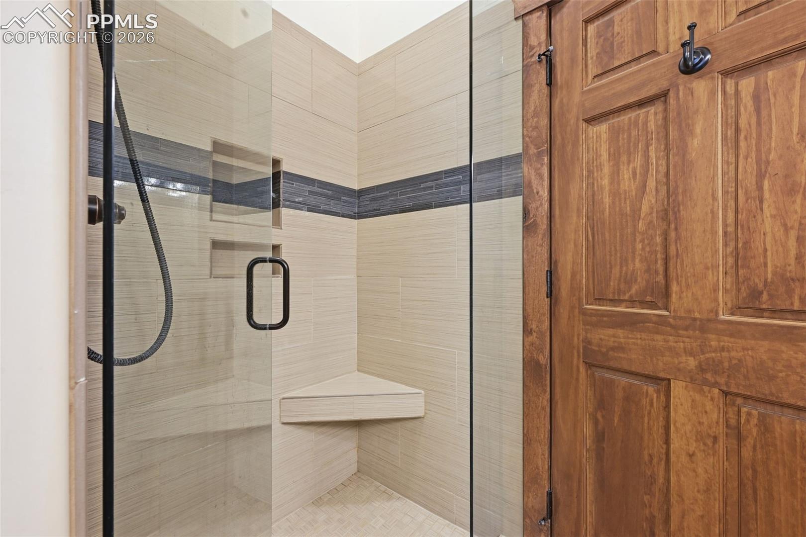 Primary Bathroom has a glass enclosed shower.