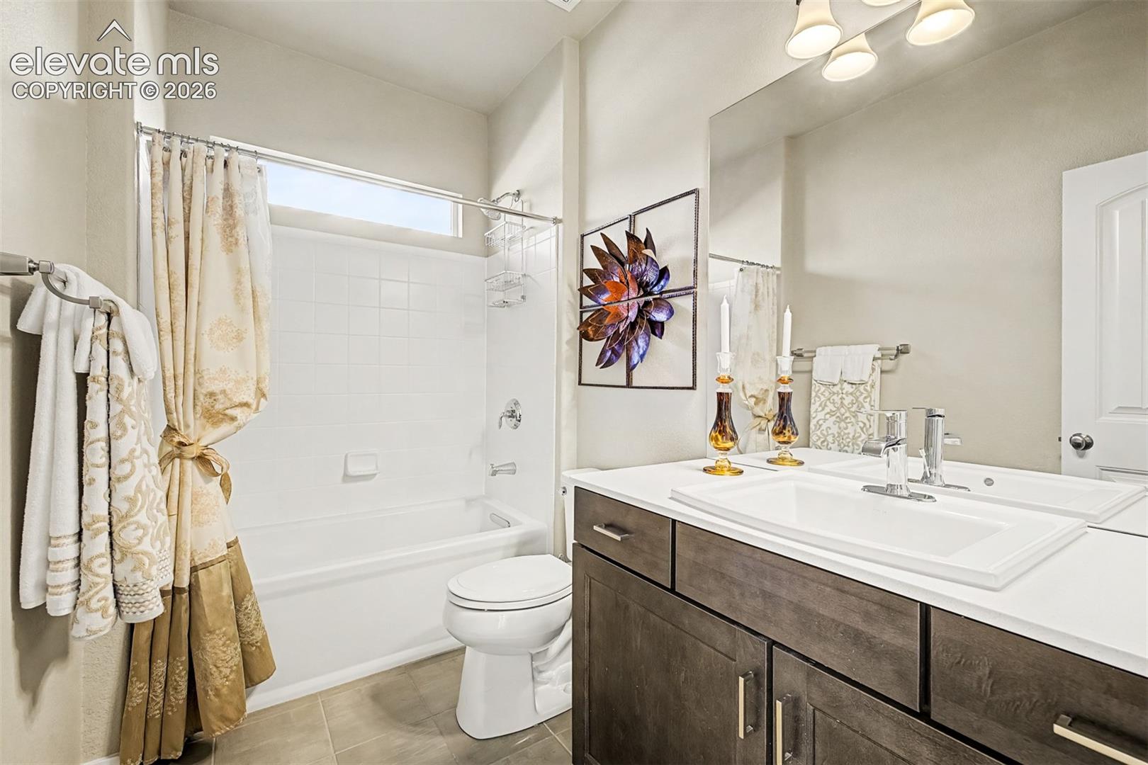 Beautifully appointed full bath on the main level complements the secondary bedroom, creating an elegant and private retreat for additional household members or guests.