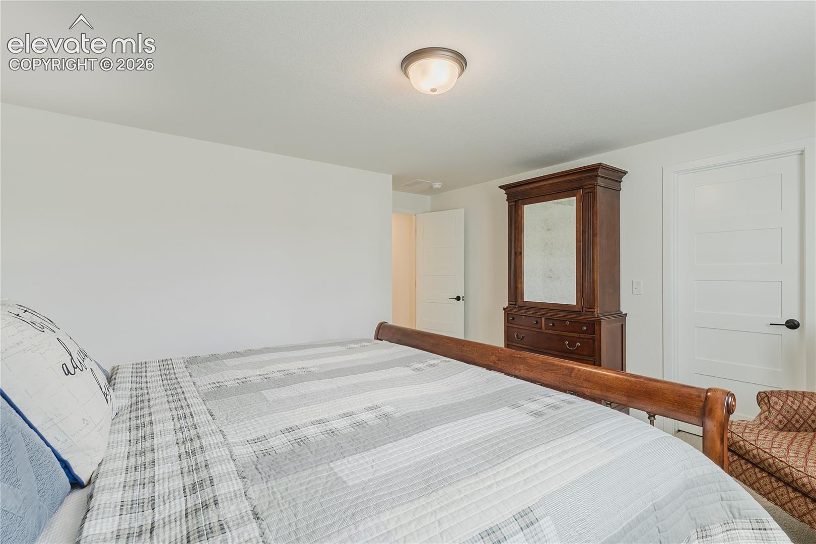 Bedroom in the lower level with plantation shutters and a walk in closet