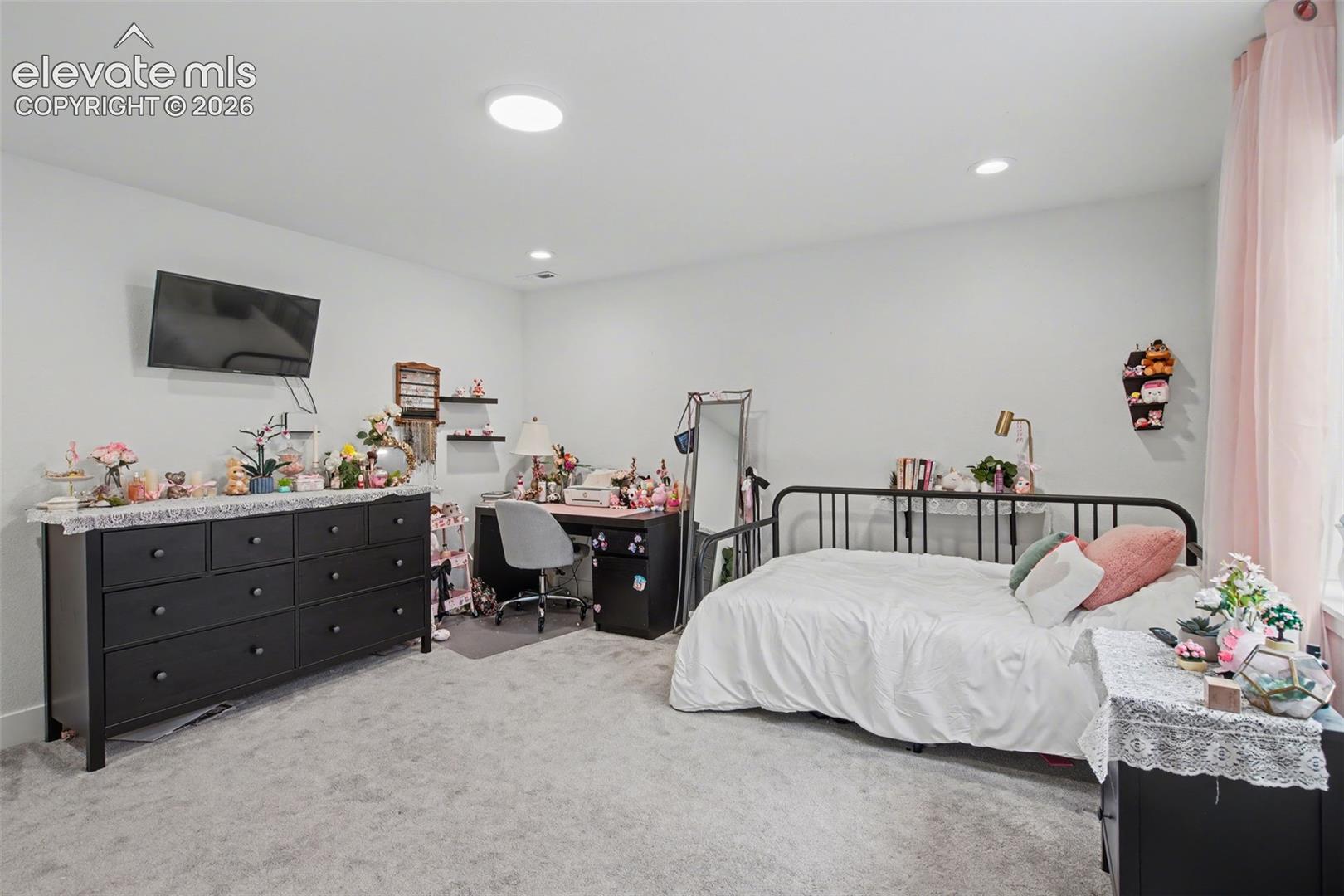 Bedroom featuring an office area, light colored carpet, and recessed lighting
