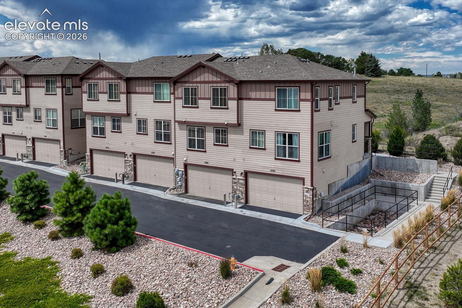 Aerial rear view of building and attached garages.
