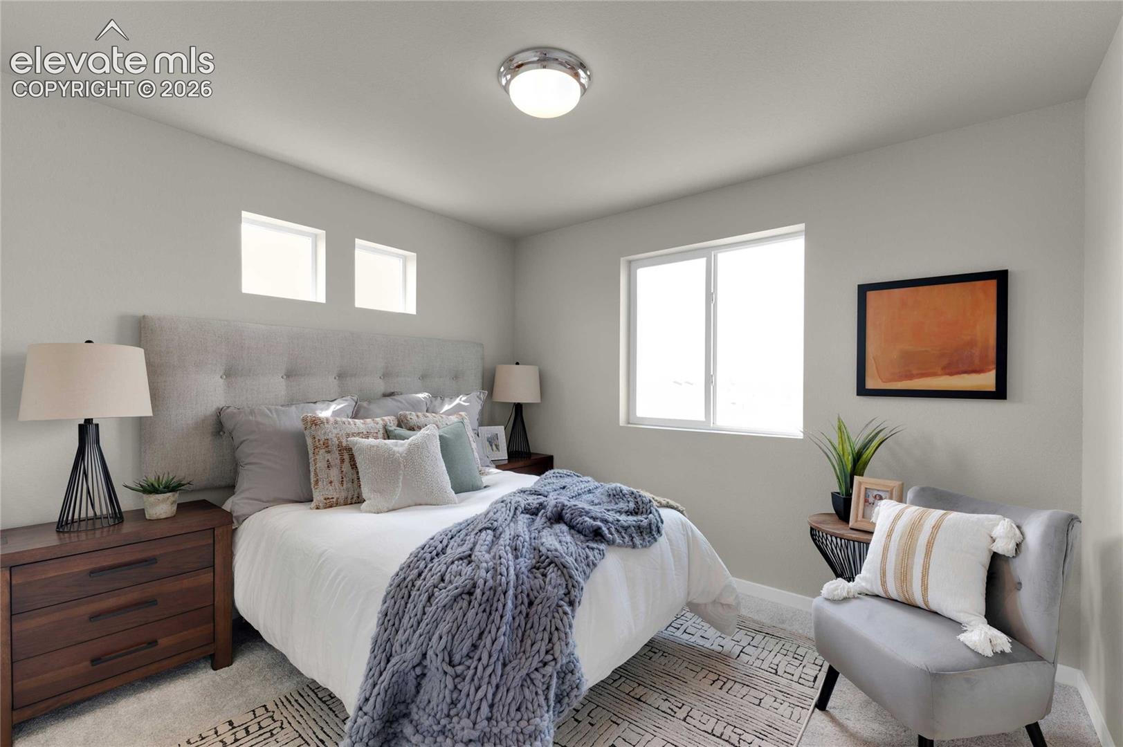 Upholstered button-tufted headboard, two transom windows, and a large picture window
*photos of a model home*
