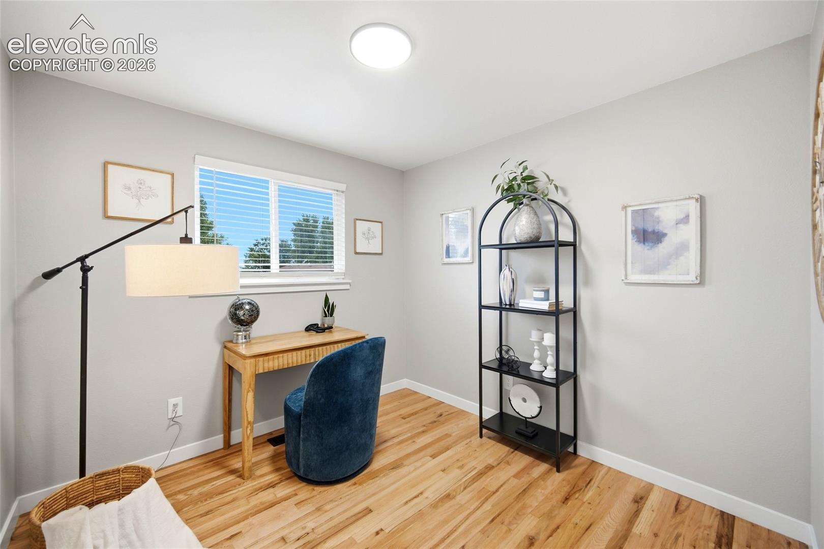 Natural wood-finish flooring, crisp white walls, and a recessed ceiling light